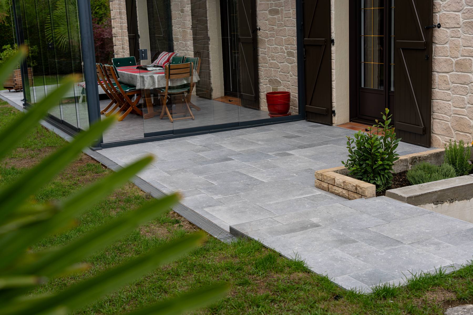 Terrasse en dalles grises devant une maison en pierre, Angel Carrelages