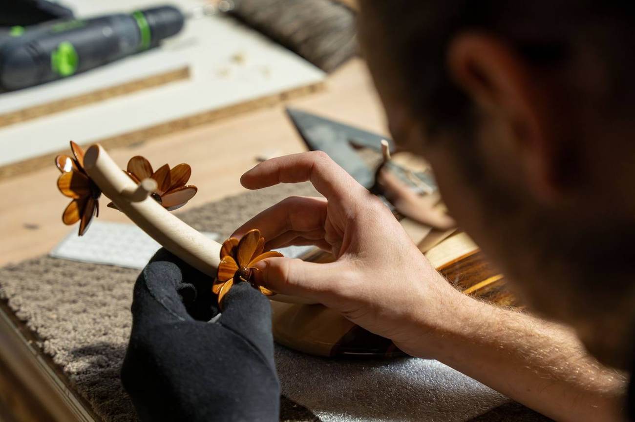 Marqueteur assemblant une fleur en bois